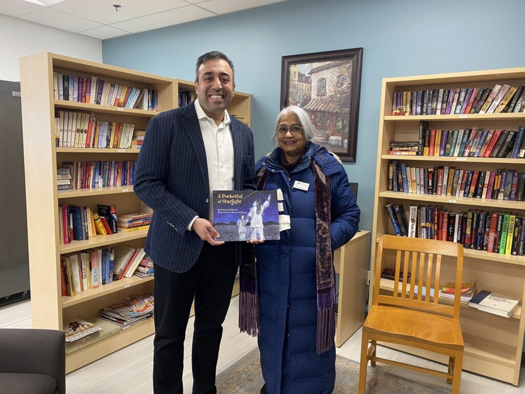 MPP Kaleed Rasheed with AACM member Rubyha, presenting her published book.